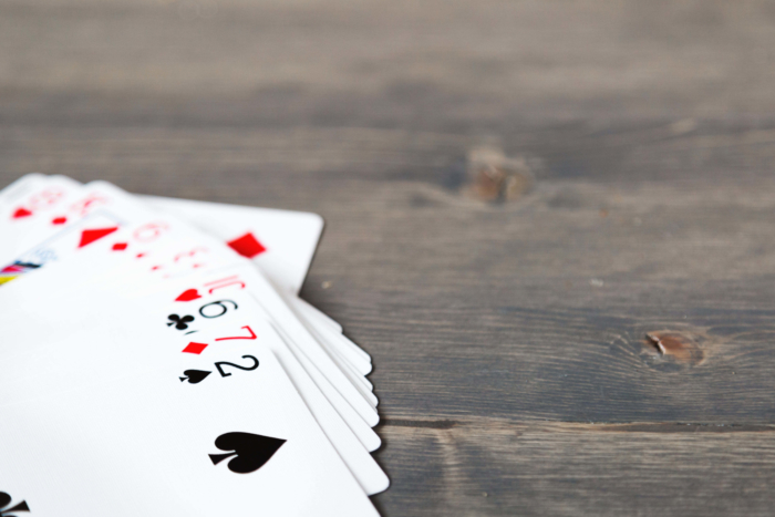 Hand of cards on wood